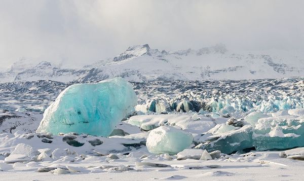 Northern shore of glacial lagoon Jokulsarlon with glacier Breidamerkurjokull